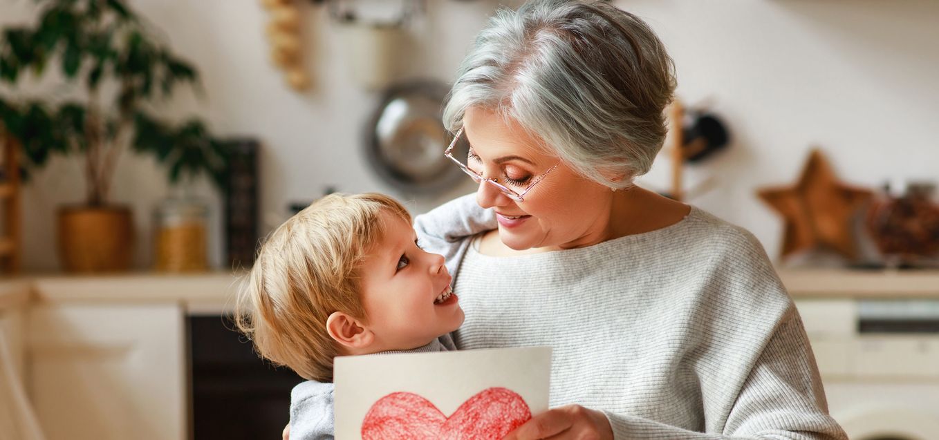 Grandmother receiving a card from grandson