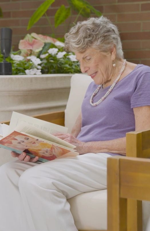 Rhona, The Capstone Resident, enjoying a book on the patio.