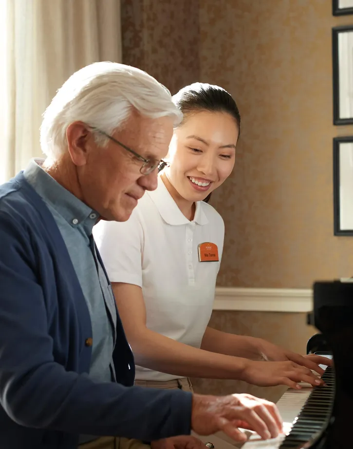 Senior and Team Member Playing Piano