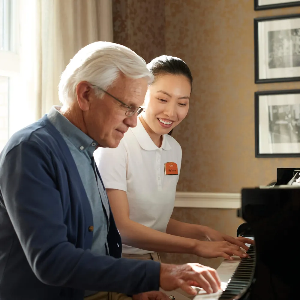 Senior and Team Member Playing Piano