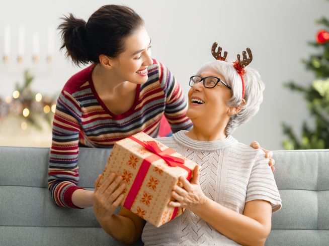 Senior woman receiving gift from daughter
