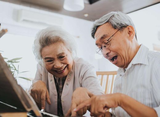 Senior couple playing piano