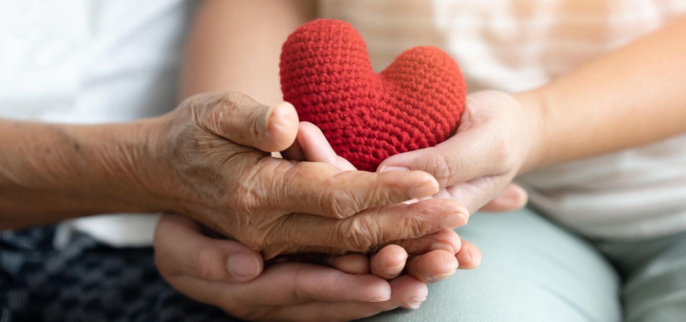Two hands holding a heart