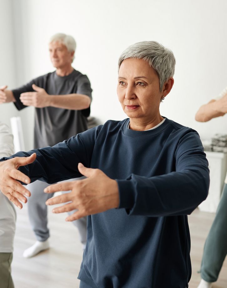 Senior residents at tai chi group fitness class