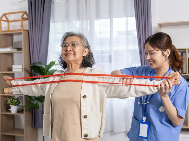 Senior woman using resistance band to exercise