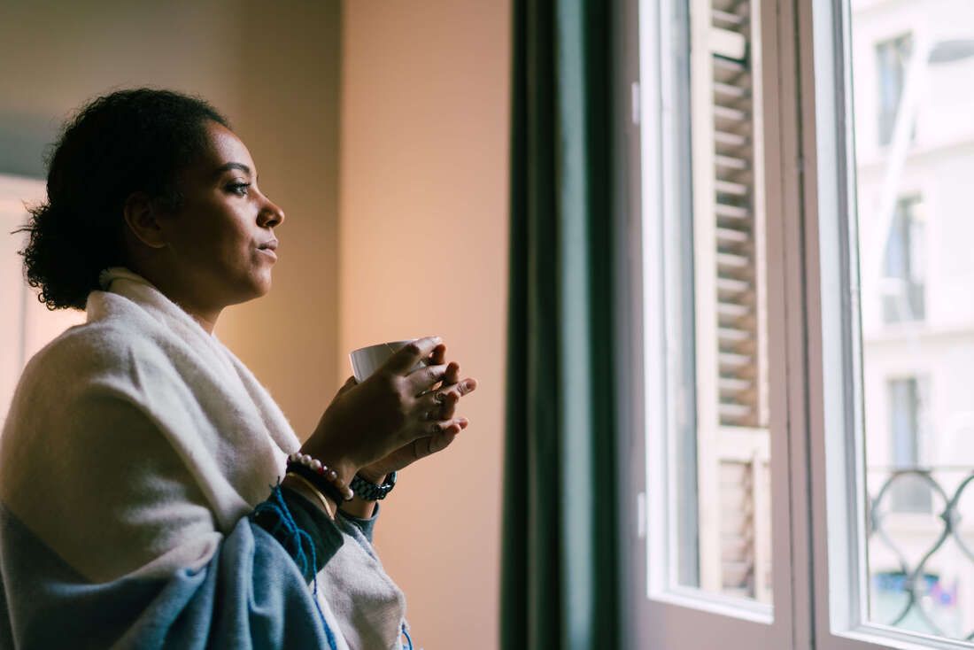 Female adult child looking out window