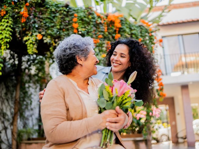 Senior woman receiving a gift from her daughter