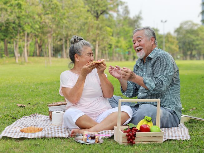 Senior couple having a picnic outdoors.