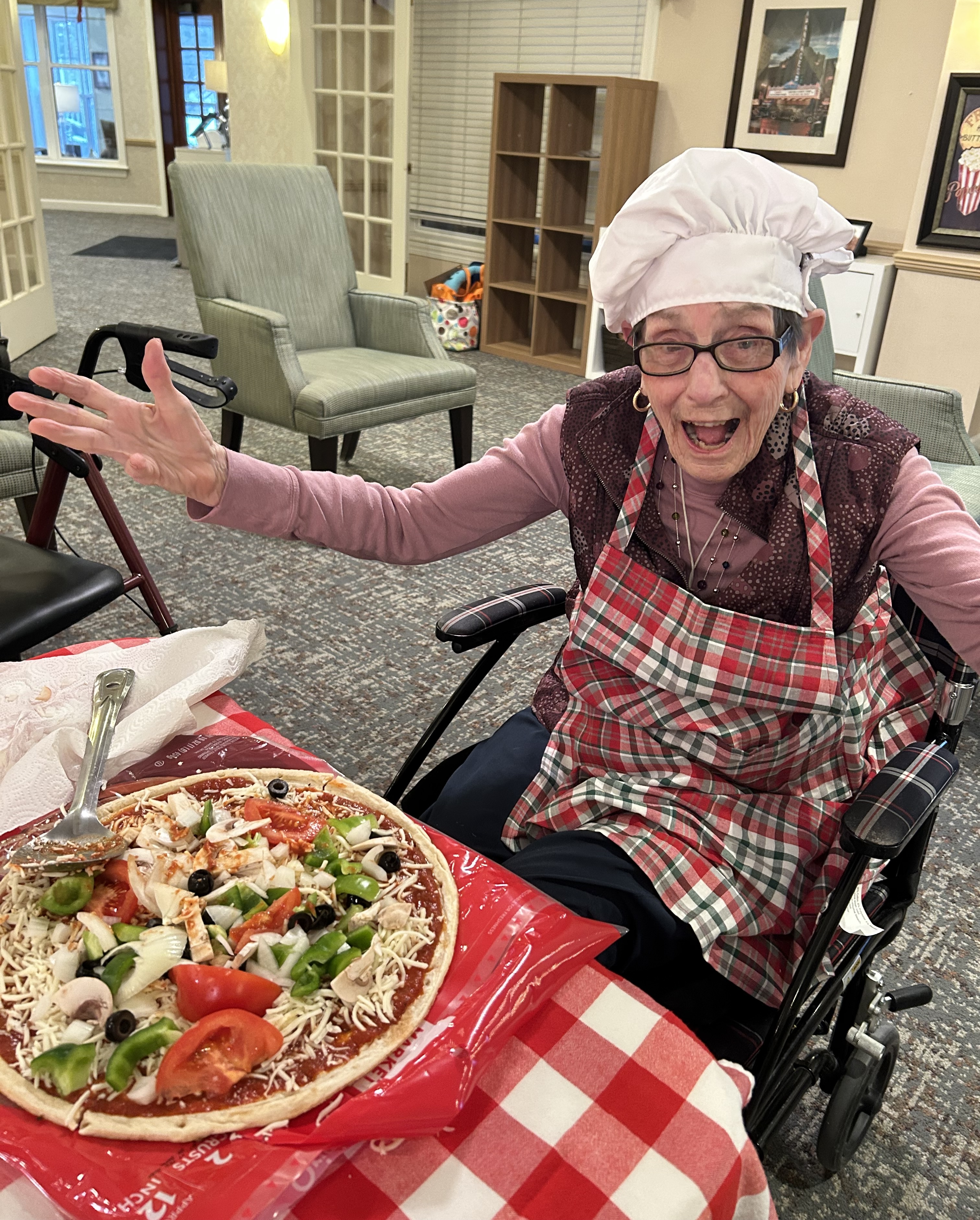 Senior living resident making pizza