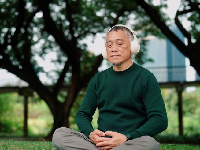 Senior man meditating outside
