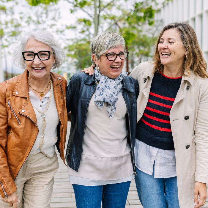 Senior friends laughing and walking outside