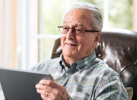 Man in chair on iPad