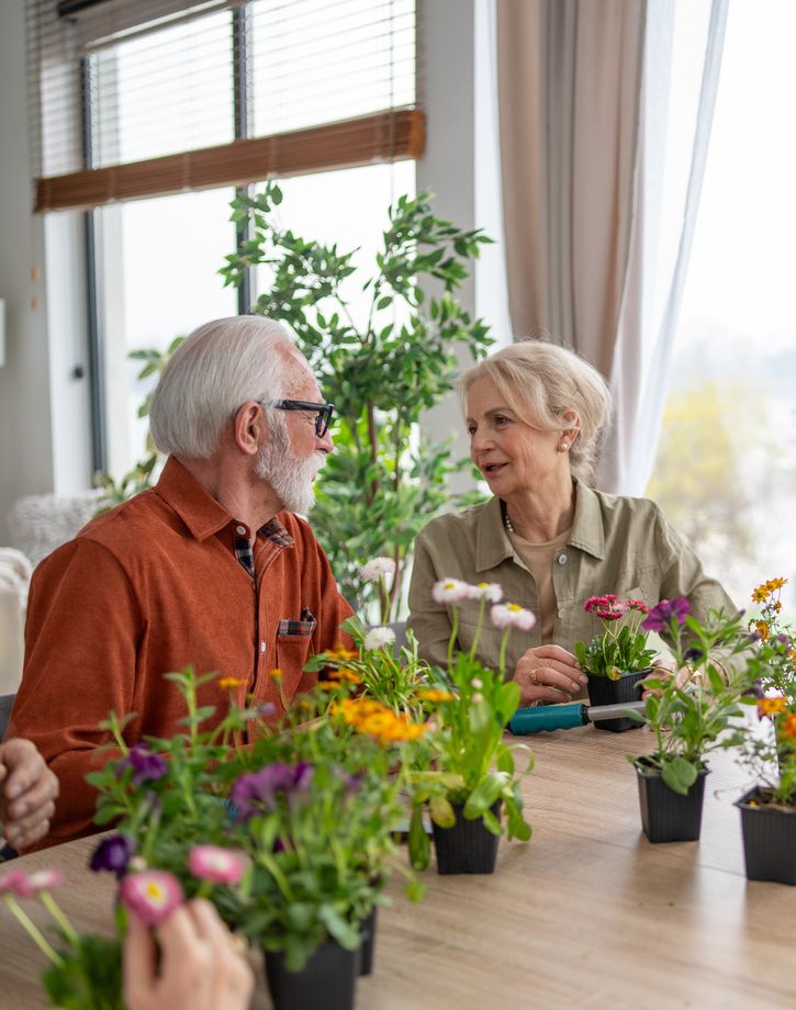 Senior resident friends arranging flowers
