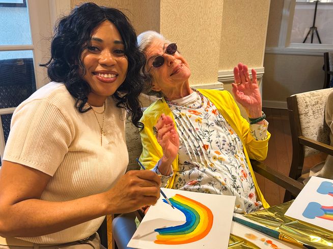 Resident and team member painting