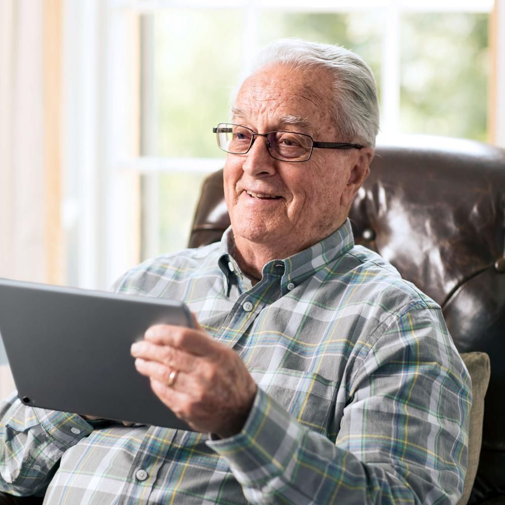 Man in chair on iPad