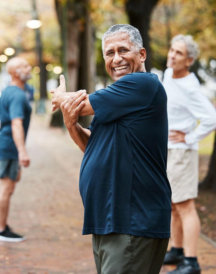 Group of seniors at walking club stretching