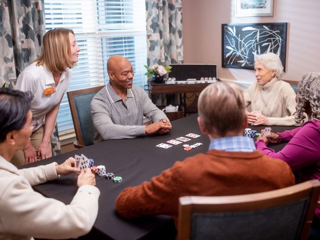 Seniors playing poker with Team Member