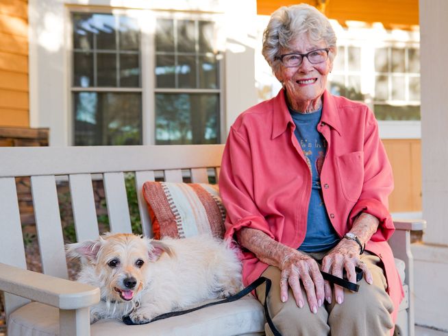 Sunrise resident sitting with a dog