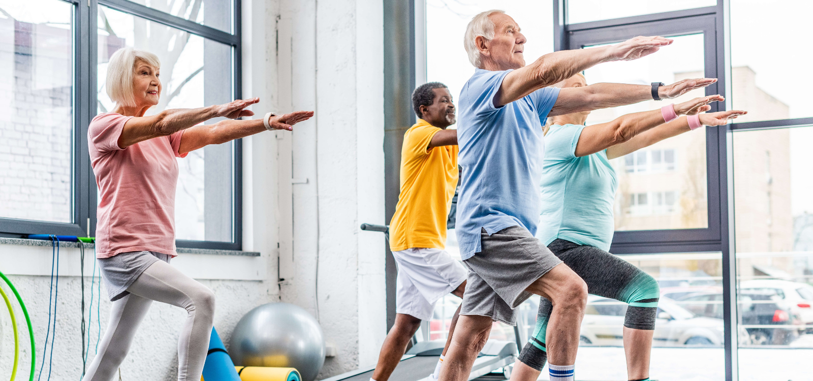 Group of seniors perform a group exercise at a workout class