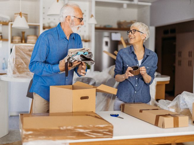 Seniors packing moving boxes