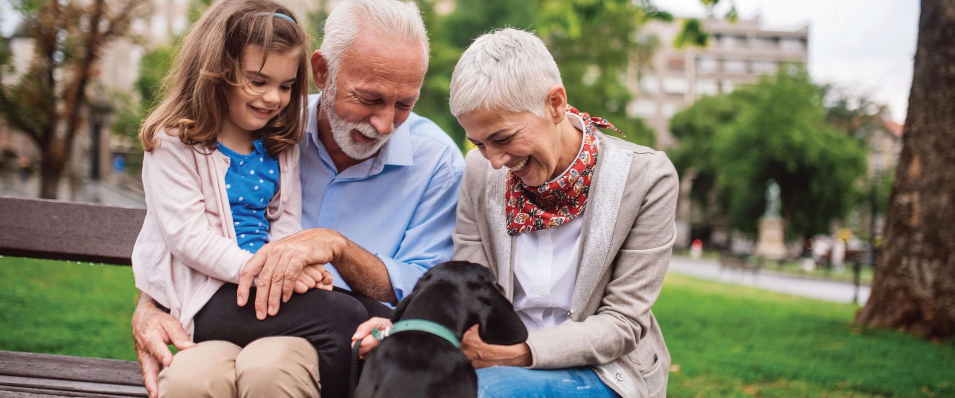 Grandparents with granddaughter and dog