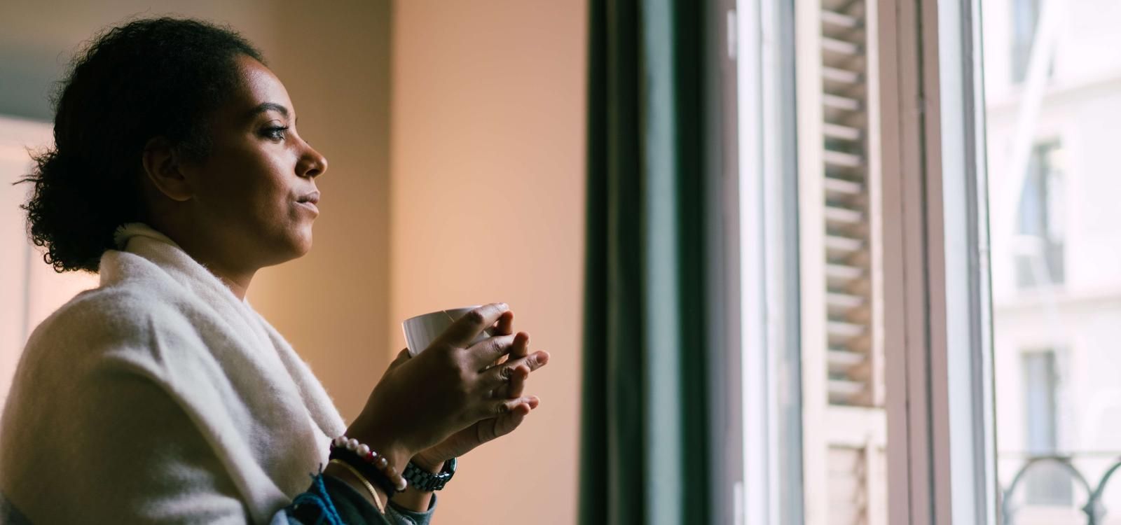 Female adult child looking out window