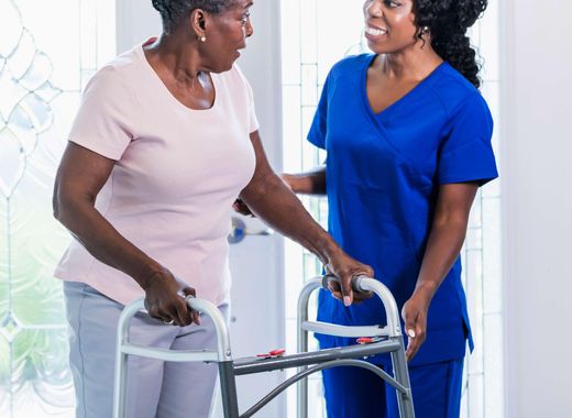 Nurse and senior woman using walker