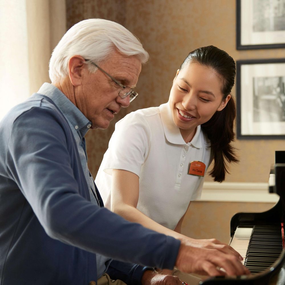 Resident and team member playing piano
