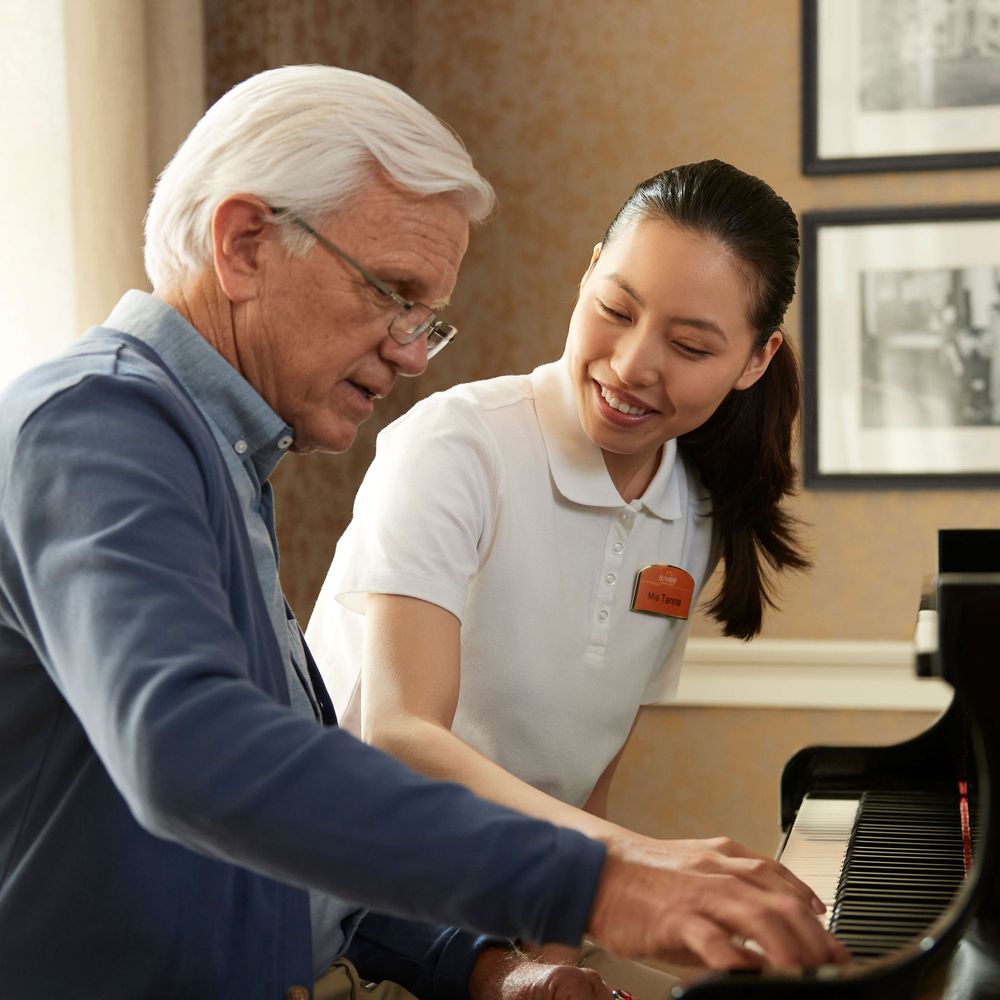 Resident and team member playing piano