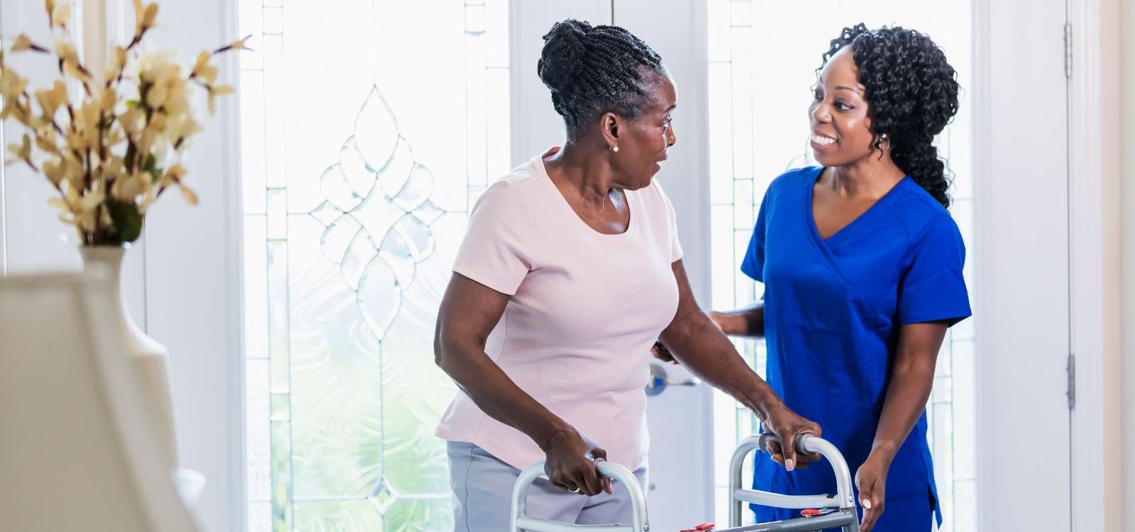 Nurse and senior woman using walker