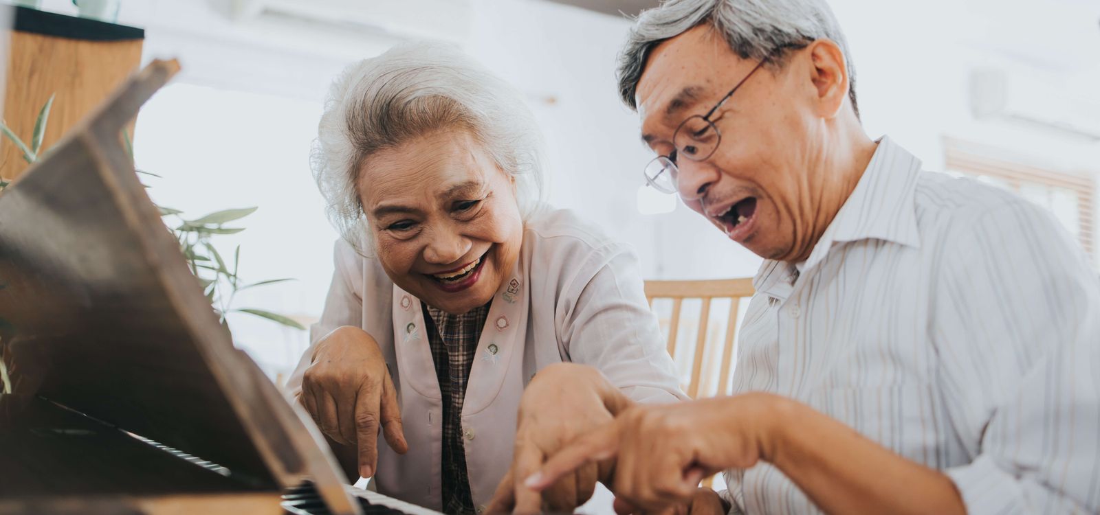 Senior couple playing piano