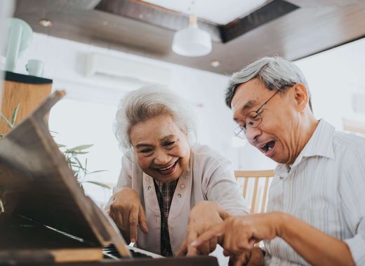 Senior couple playing piano